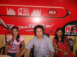 Kavita and Pradipta with  RJ at RED FM Telecast studio 